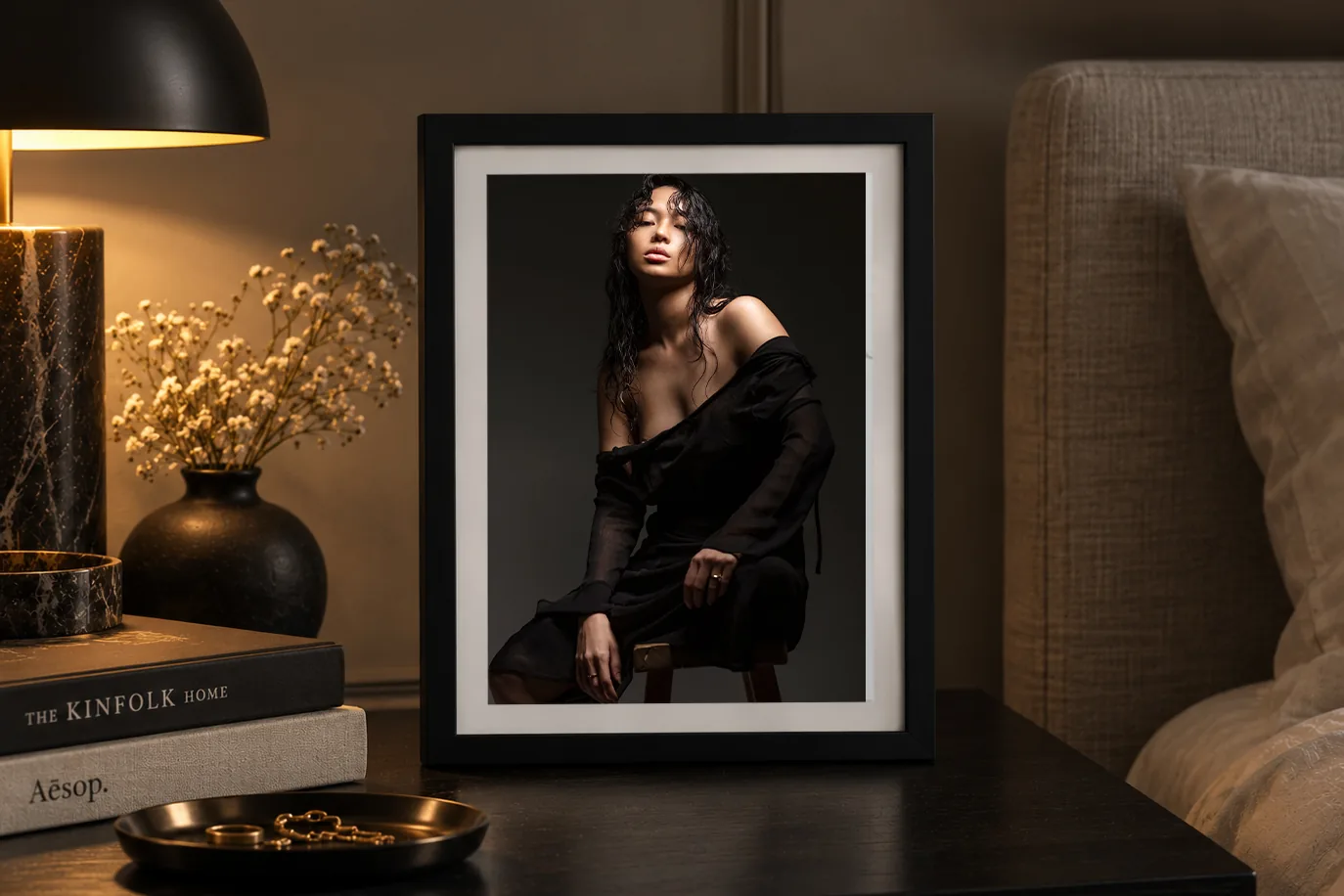 Framed boudoir portrait on a bedside table